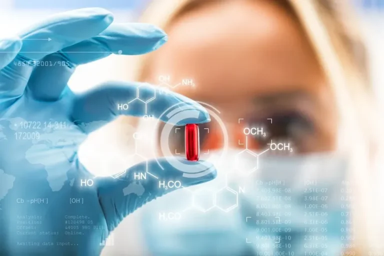 Person in medical gloves holding a red capsule with digital molecular structures and pharmaceutical data overlays in the background.
